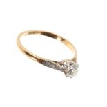 Diamond single stone ring with an old cut diamond in claw setting with diamond set shoulders
