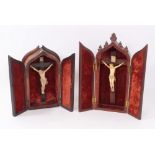 19th century carved ivory crucifix in gothic mahogany case, together with another similar example