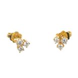 Pair of diamond earrings, each with three brilliant cut diamonds