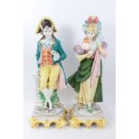 Pair of Continental period costume figurines with decorative bases