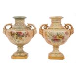 Two Edwardian Royal Worcester blush ivory ground vases with moulded human mask handles, floral