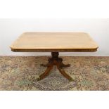 Regency mahogany breakfast table with rounded rectangular top, on four splayed legs and brass