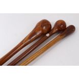 Three marquetry topped walking sticks of intricate design incorporating different woods, varying