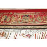 Chinese embroidered red silk banner. Officials, deities and Gods in garden scene with pagoda and
