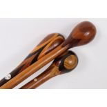 Three marquetry topped walking sticks of intricate design incorporating different woods, varying