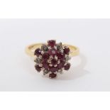 18ct gold ruby and diamond cluster ring with a flower head cluster in tiered claw setting on 18ct