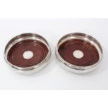 Pair of contemporary silver wine coasters with beaded edge and turned mahogany bases. Birmingham