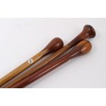 Three marquetry topped walking sticks of intricate design incorporating different woods, varying