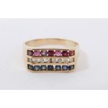 Diamond, ruby and sapphire triple row ring with round cut stones in 14K yellow gold channel setting