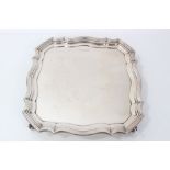 George V silver salver of shaped square form.