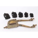 Set of five graduated brass elephant weights and brass cutter