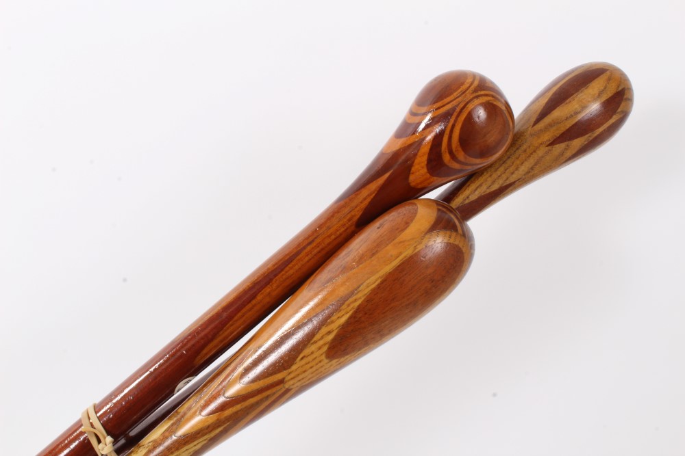 Three marquetry topped walking sticks of intricate design using different woods, varying lengths