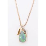 Opal and diamond pendant with a pear shaped opal cabochon in diamond set mount on chain