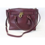 Michael Kors mulberry leather handbag with logo padlock to front. Engraved zipper pull and MK logo