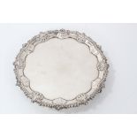 George III silver waiter of circular form with stylized shell, leaf and gadrooned border.