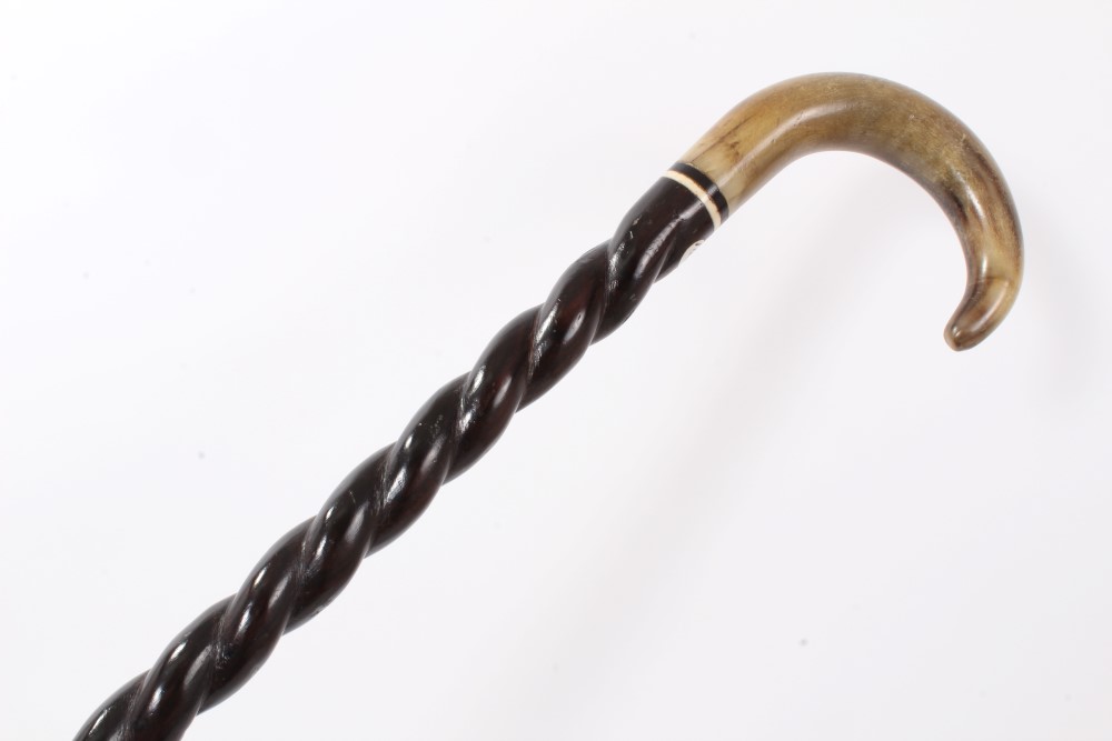 Late 19th century heavy walking stick with twisted ebonised shaft inset with ivory washer and horn