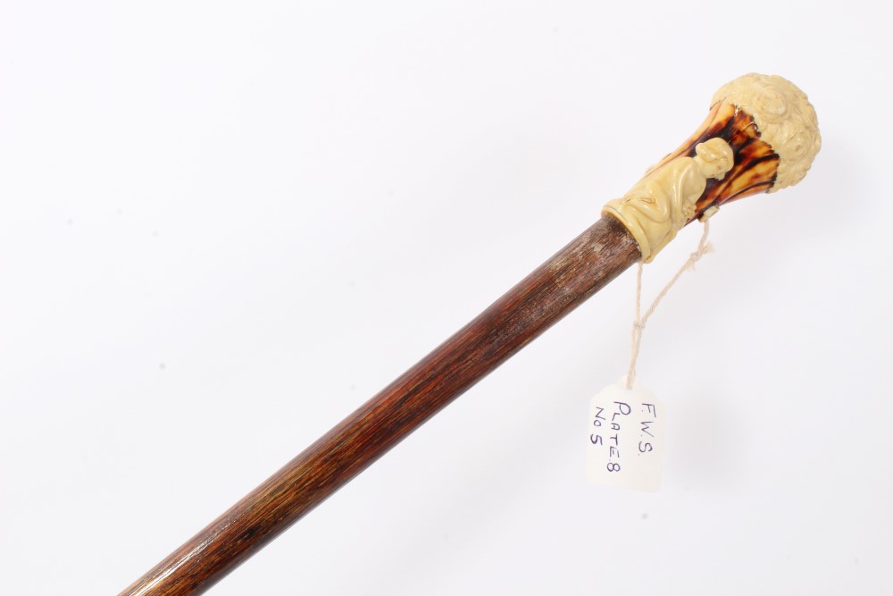 Early 20th century Hickory walking stick with moulded earthenware in the form of a classical child