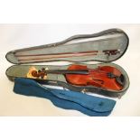 A violin with two bows in fitted case