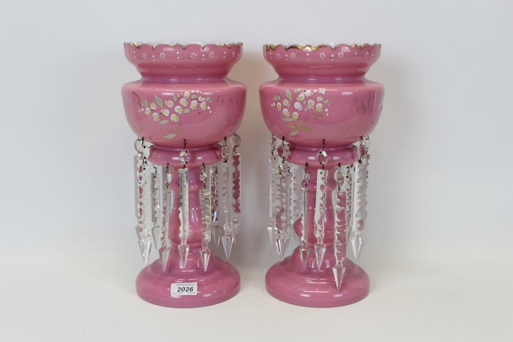 Pair of Victorian pink glass lustres with enamelled floral decoration and prismatic drops, 37cm in