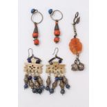 Pair of Chinese earrings with coral beads, one other pair and a single earring