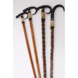 Four Alpine walking sticks with Ibex horn handles and spiked ferrules, one inscribed "Interlaken"