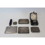 Four silver cigarette cases, silver vesta case, silver napkin ring in fitted case and blue glass