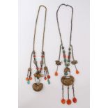 Two old Chinese necklaces with white metal panels and carved agate, coral and mother of pearl beads