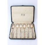 Set of six Liberty silver tea spoons with cast scroll to the handles. Maker’s mark for Liberty and