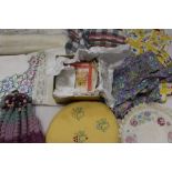 A quantity of table linens including embroidered and lace cloths, and mats, Linen table cloth with