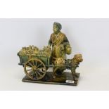 Unusual large pottery figure group of an elderly lady with a dog pulling a cart, approx 26cm in
