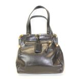 Prada Handbag in soft Nappa black leather. Two handles and hanging tag. Zipped pockets. Black logo