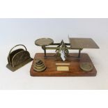 Brass letter rack with fish ornament and antique parcel scales on oak base