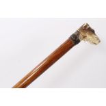 Late 19th century/early 20th century glove stick with metal collar surmounted by a composite handle