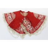 Chinese embroidered red silk child's cape with birds and flowers in forbidden stitch edging. Plus a