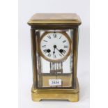 19th century brass and four glass cased clock with enamel dial and French movement, complete with