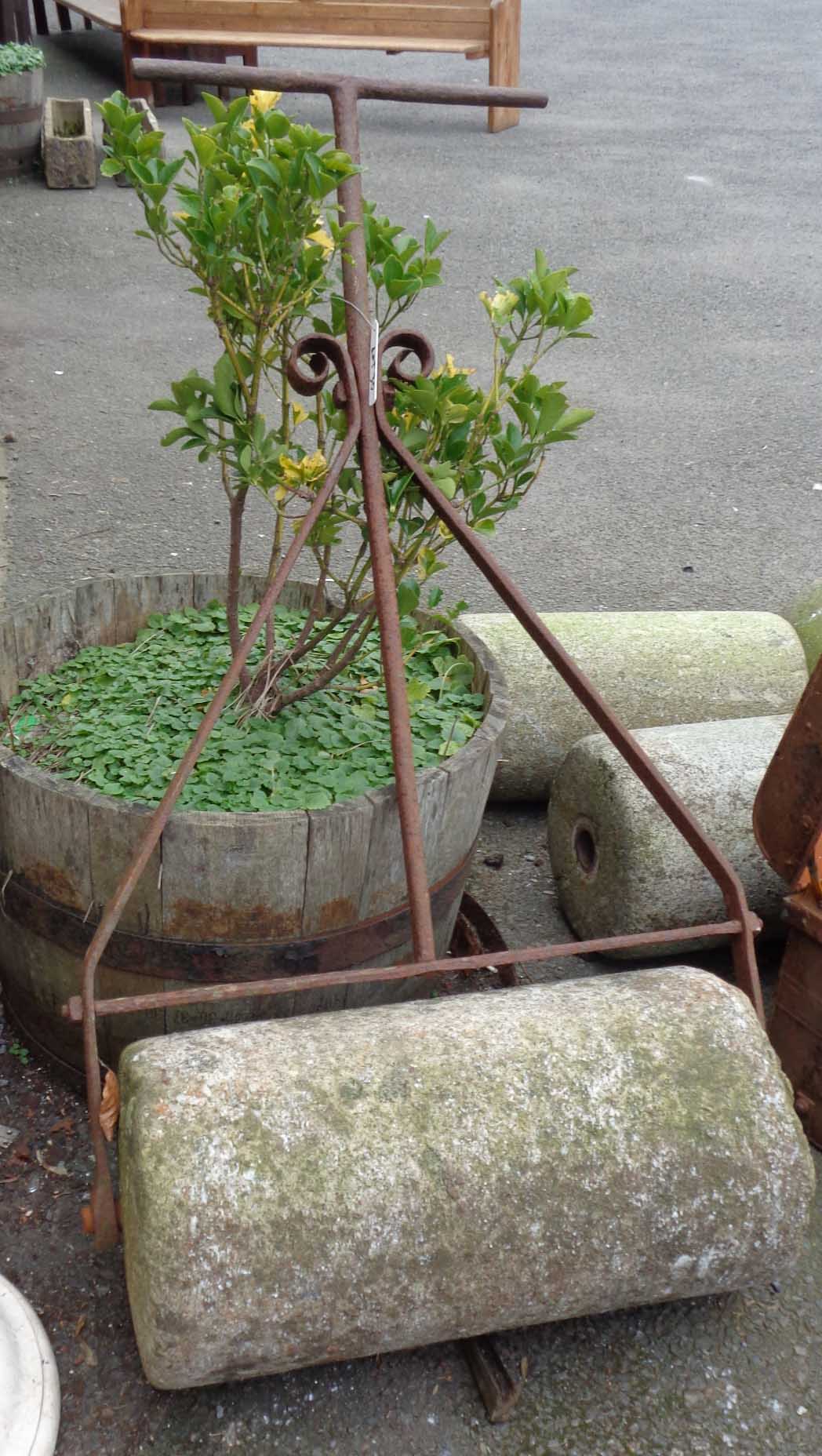 A 24" antique granite garden roller with wrought iron handle