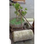 A 24" antique granite garden roller with wrought iron handle