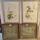 A pair of framed oriental silk work panels, depicting birds within decorative woven borders - sold