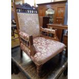 An Edwardian walnut framed drawing room armchair with decorative top rail, turned spindles and