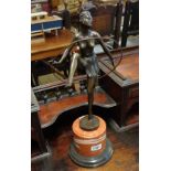 A bronzed Art Deco style dancer with a hoop set on a socle base - height 19"