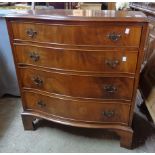 A 31" reproduction mahogany serpentine front chest of four long graduated drawers, set on bracket