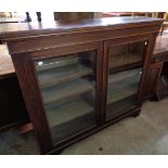 A 3' 11" Edwardian walnut book cabinet with three adjustable shelves enclosed by a pair of glazed