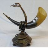 A carved horn of plenty mounted by a cobra and set on a reeded base