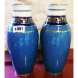 A pair of Royal Doulton baluster vases with banded blue and white decoration and gilt detail