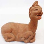 An antique Indonesian pottery figure of a mythical hybrid bull with human head