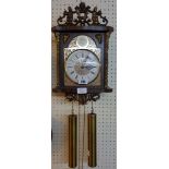 A modern polished wood cased pendulum wall clock, with twin weight driven chiming movement