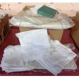 A box containing a quantity of linen including embroidered cut work, crochet table linen, etc.