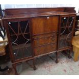 A 5' early 20th Century walnut side-by-side bureau bookcase with moulded raised top, fully fitted