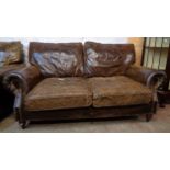 A 5' 8" studded brown leather upholstered two seater settee and armchair to match - the settee