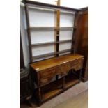 A 4' 5" polished oak potboard dresser with three frieze drawers, two flanking shorter